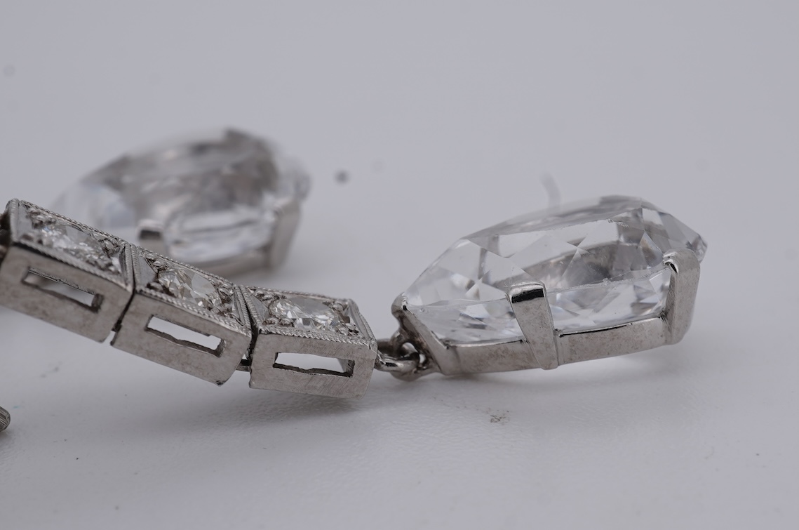 A pair of white metal and four stone diamond set earrings, each with a cubic zirconia pear shaped drop, overall 42mm.